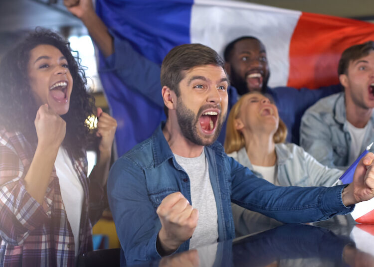 Emotional french spots supporters with flag happy about victory in championship