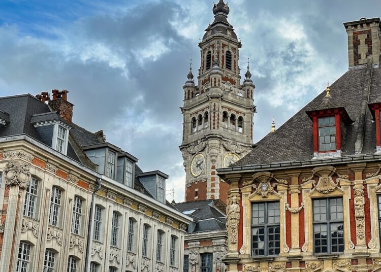 Lille, France - April 12 2023: the beffroi of lille tower visible from an square with historic buildings